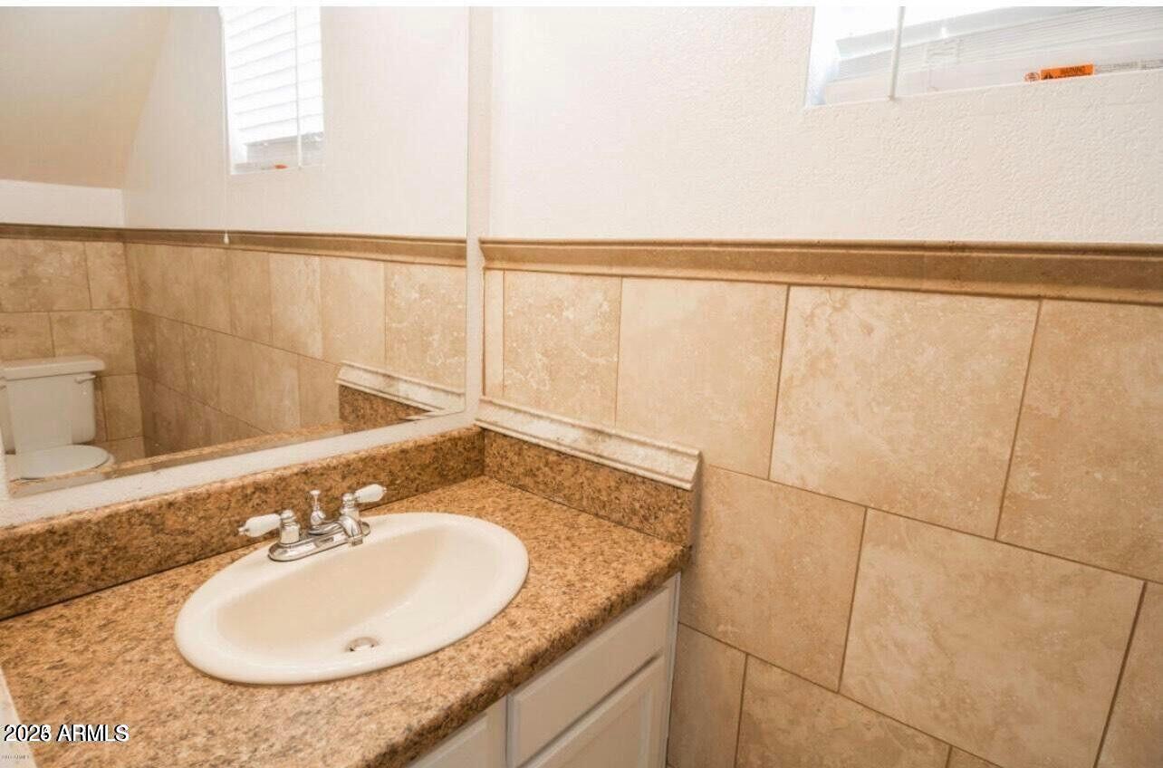 16225 North 30th Street, Unit 9 Phoenix, AZ 85032 - Photo 6 of 19 a bathroom with a granite countertop sink and a mirror