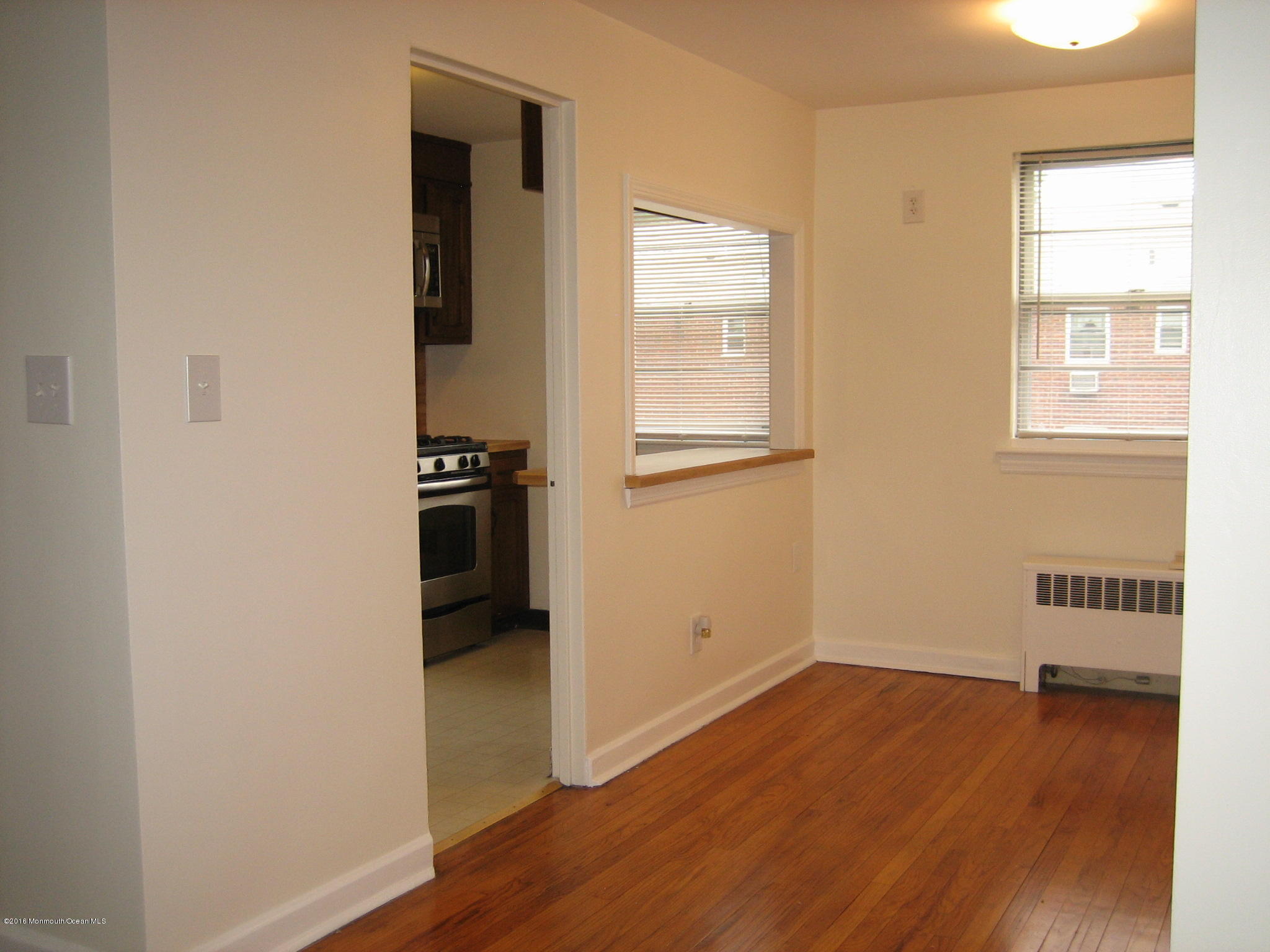 169 Manor Drive Red Bank, NJ 07701 - Photo 6 of 12 an empty room with wooden floor and windows