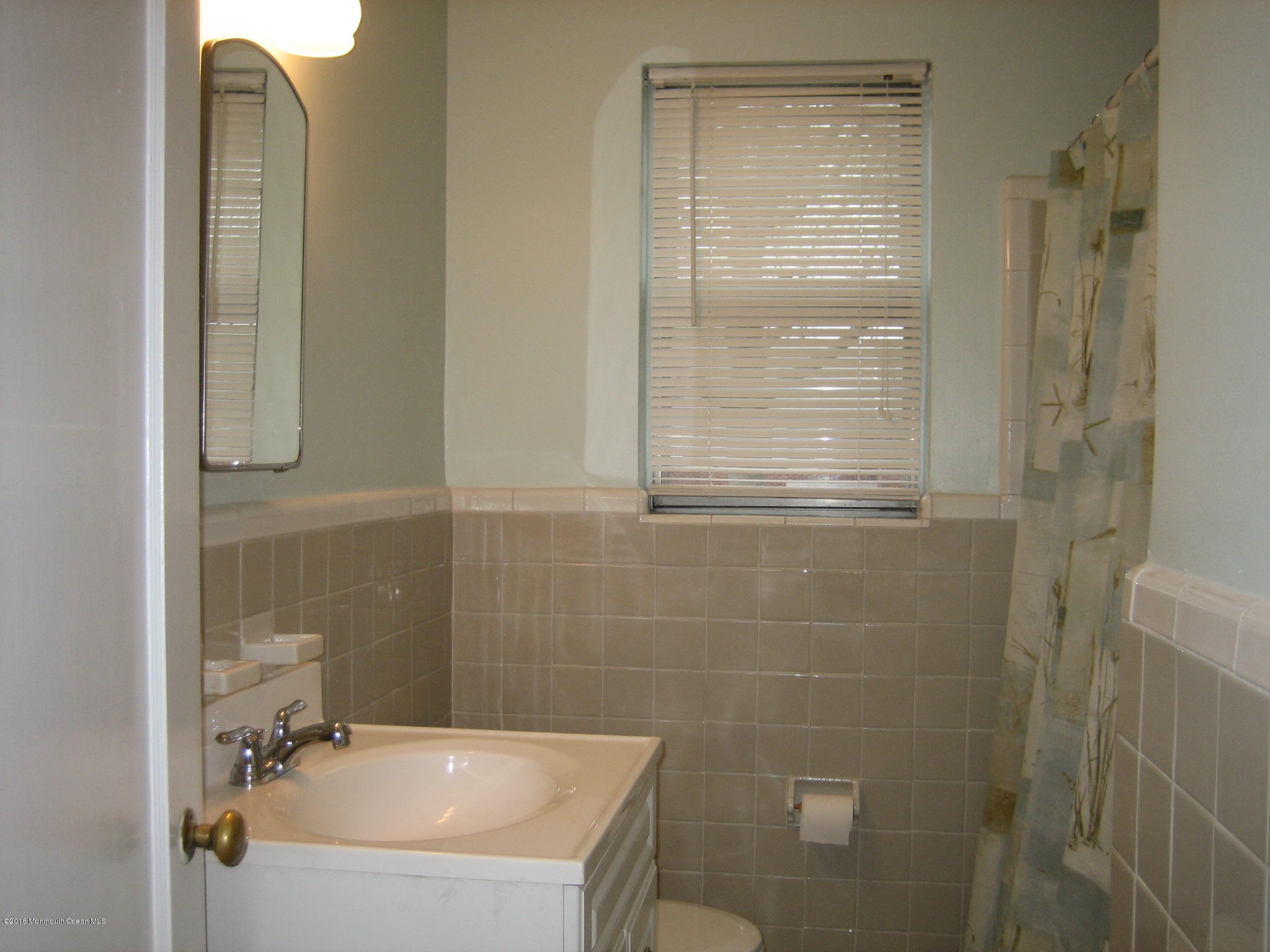 169 Manor Drive Red Bank, NJ 07701 - Photo 9 of 12 a bathroom with a sink a window and a shower