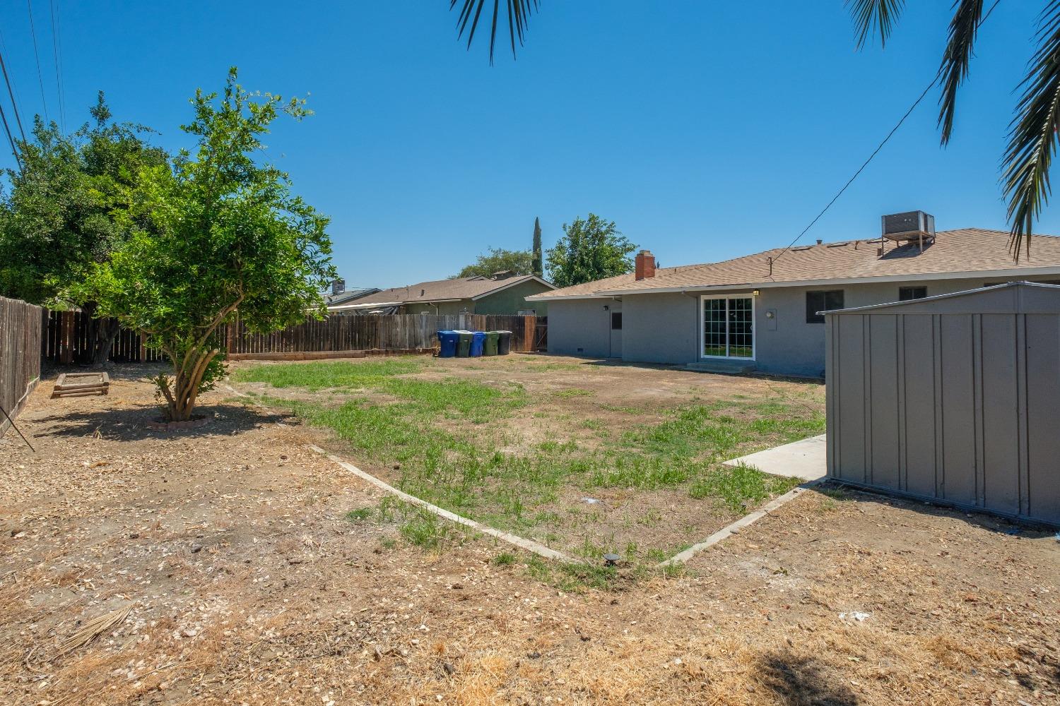 194 West Spring Lane Lemoore, CA 93245 - Photo 13 of 15 a view of a house with a backyard