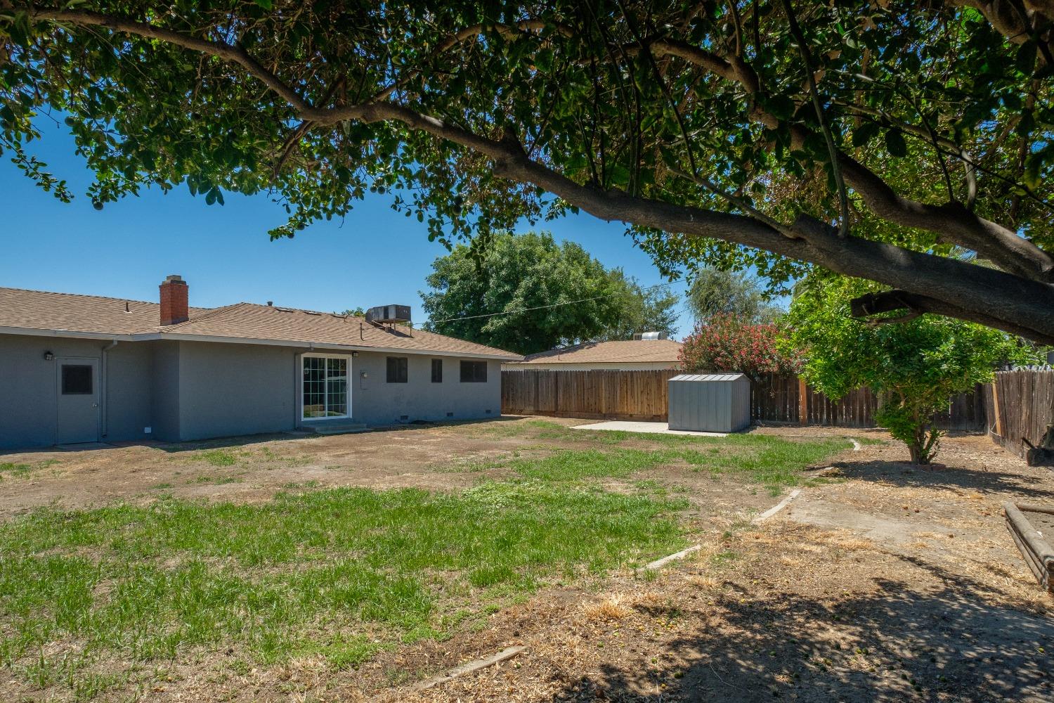 194 West Spring Lane Lemoore, CA 93245 - Photo 14 of 15 a front view of a house with a yard and trees