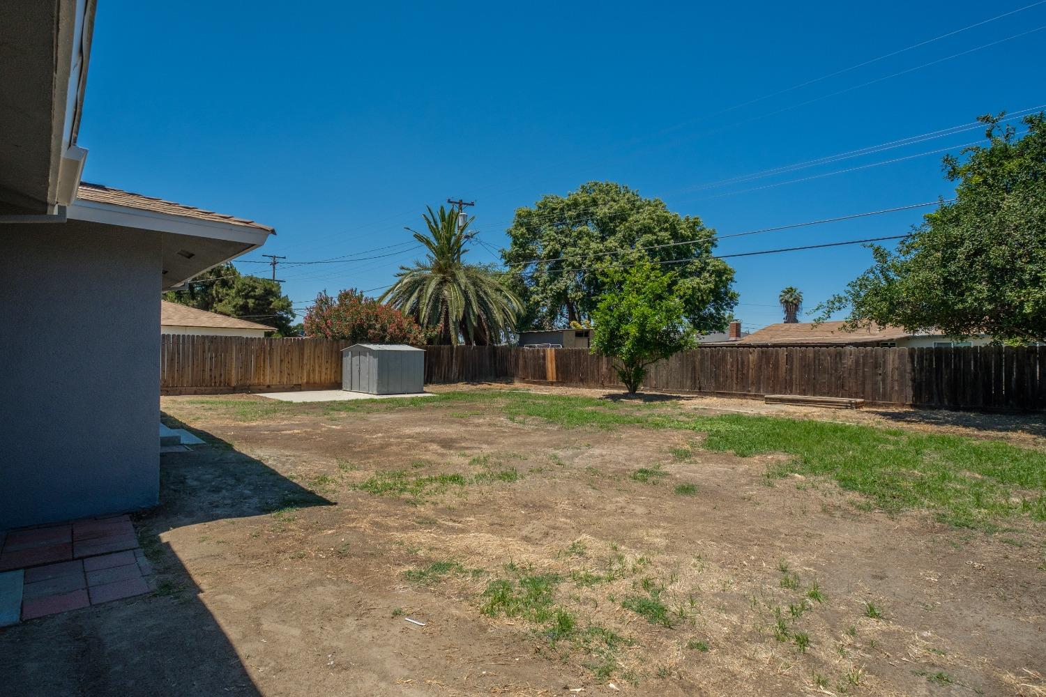 194 West Spring Lane Lemoore, CA 93245 - Photo 15 of 15 a view of a backyard with green space