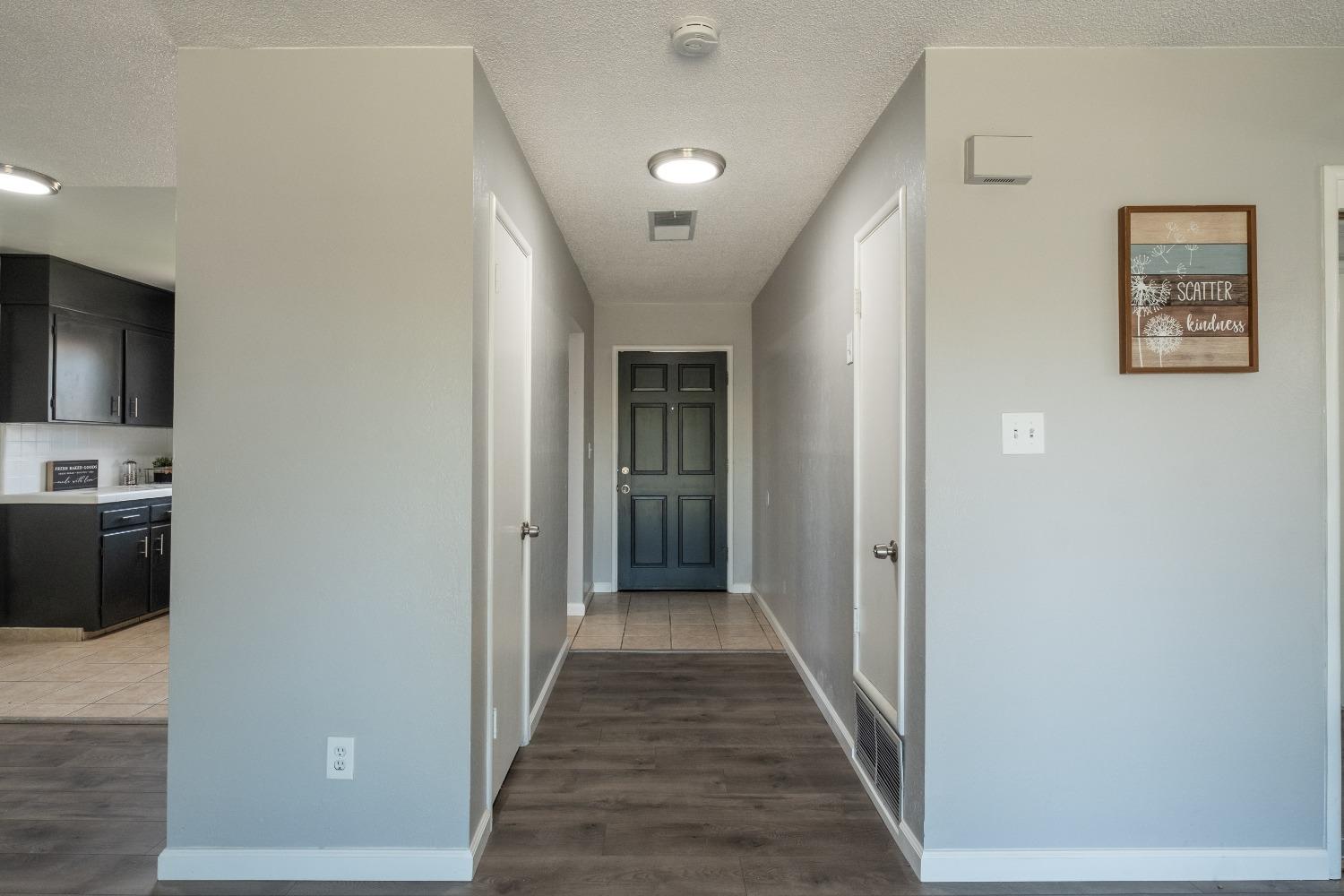194 West Spring Lane Lemoore, CA 93245 - Photo 4 of 15 a view of a hallway with a livingroom and a couch
