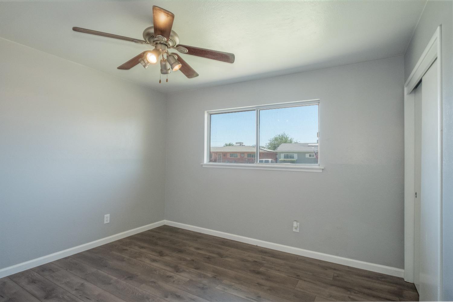 194 West Spring Lane Lemoore, CA 93245 - Photo 8 of 15 a view of wooden floor in a room