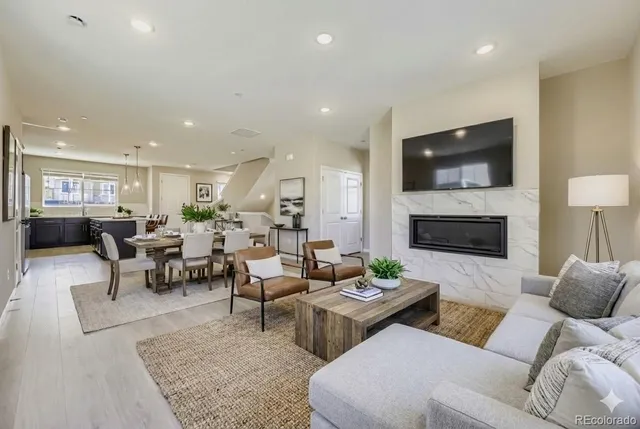 a living room with furniture fireplace and a flat screen tv