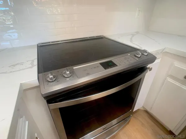 a stove top oven sitting inside of a kitchen