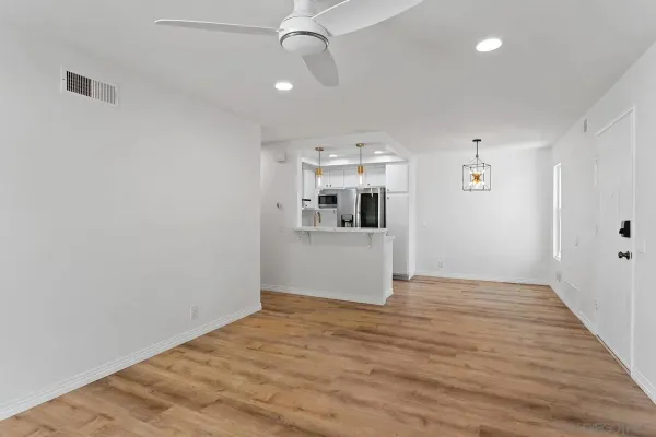 a view of a kitchen with a sink and a refrigerator