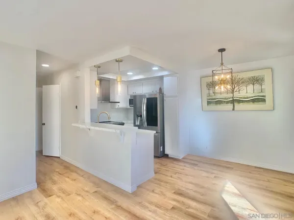 a view of kitchen with refrigerator and window
