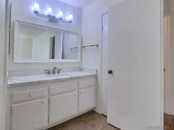 a bathroom with a double vanity sink and a mirror