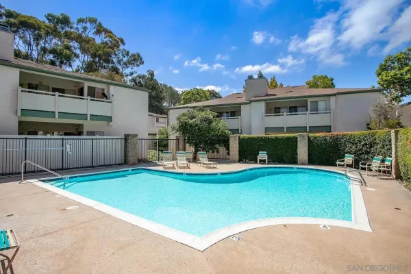 a view of a house with swimming pool and sitting area
