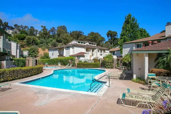a view of a house with swimming pool and sitting area