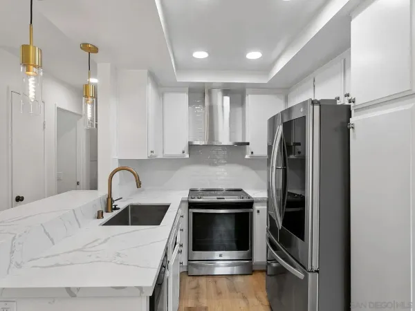 a kitchen with a refrigerator sink and cabinets