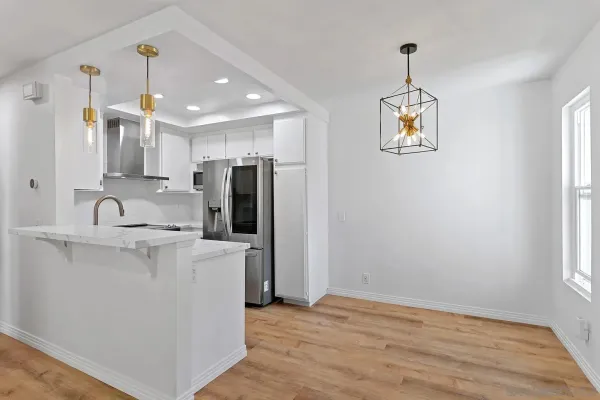 a kitchen with stainless steel appliances a refrigerator sink and microwave