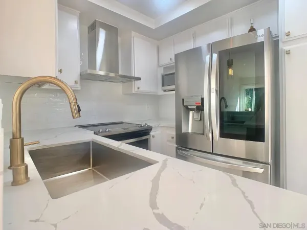 a view of a kitchen with a sink and washing machine