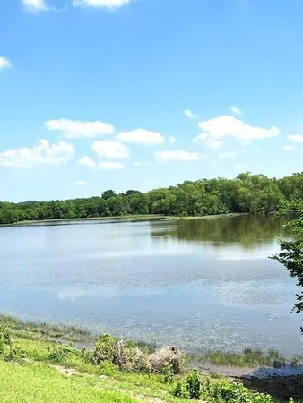 a view of field with trees in the background