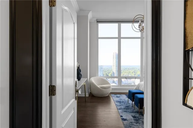 a living room with a bed furniture and a window