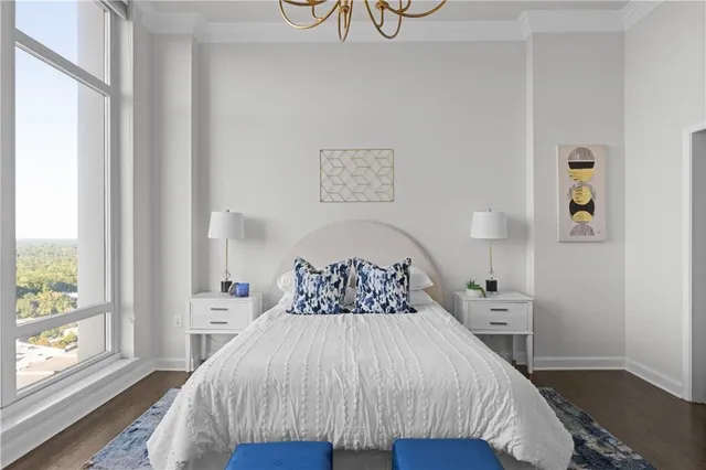 a bedroom with a bed and a large window