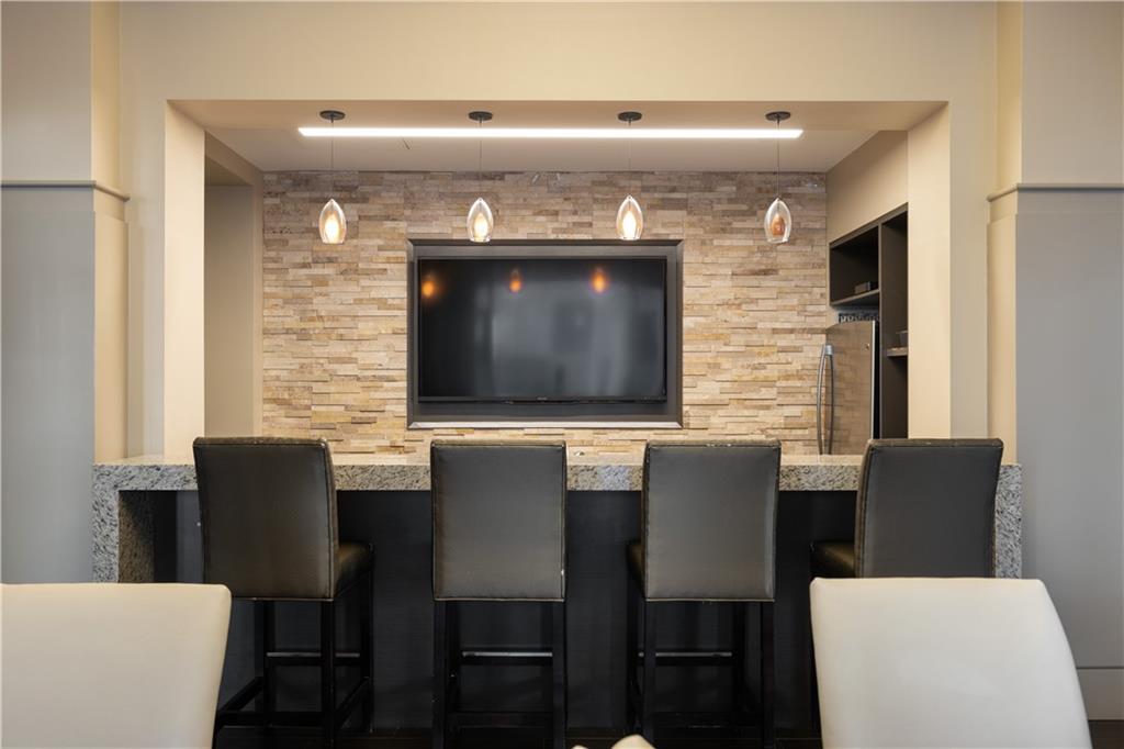 3475 Oak Valley Road Northeast, Unit 2820 Atlanta, GA 30326 - Photo 66 of 86 a kitchen with a table chairs and a fireplace