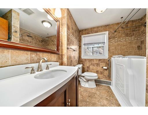 107 Oak Street Middleboro, MA 02346 - Photo 16 of 24 a bathroom with a granite countertop sink toilet a mirror and shower