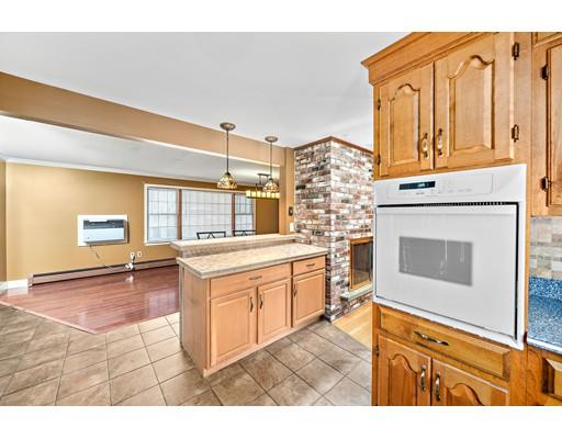107 Oak Street Middleboro, MA 02346 - Photo 6 of 24 a living room with stainless steel appliances kitchen island granite countertop furniture and a fireplace