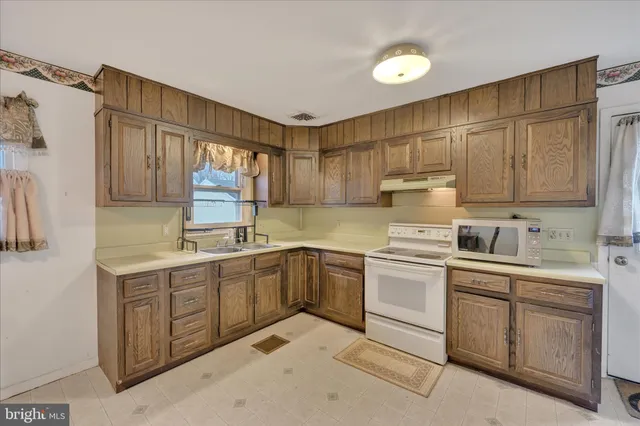 a kitchen with a sink cabinets and window