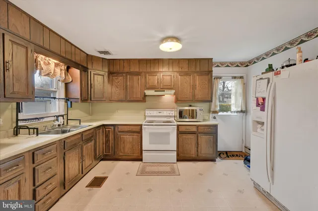 a kitchen with a sink stove and refrigerator