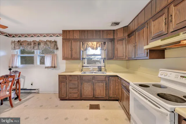 a kitchen with a sink cabinets and window