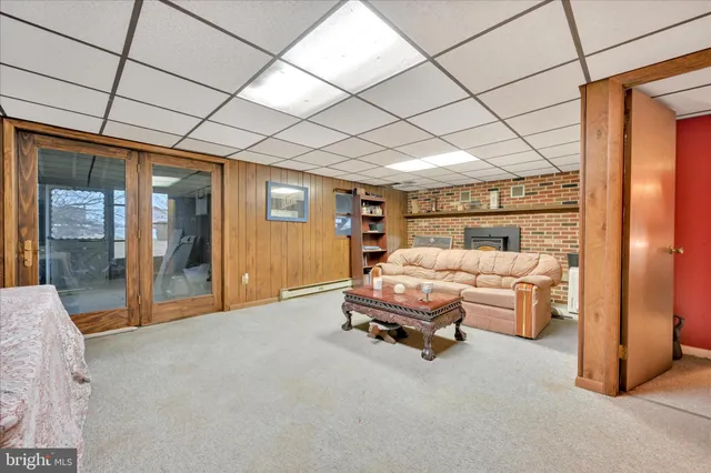 a bedroom with furniture and large window