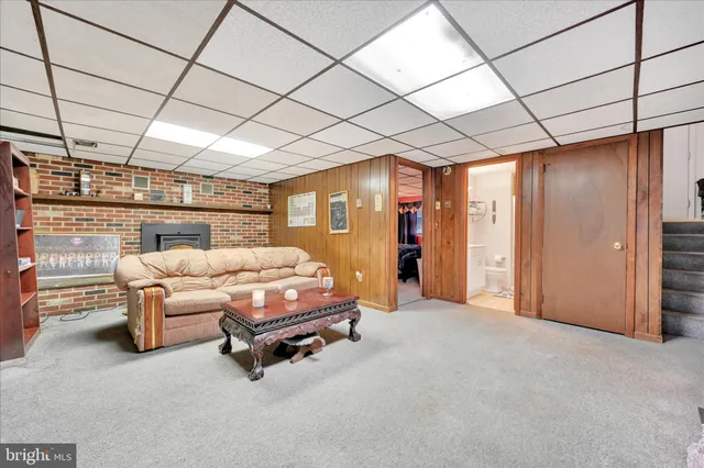 a bedroom with furniture and a large window