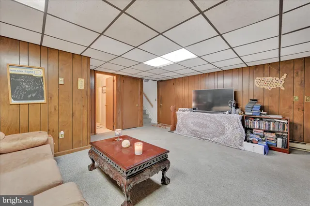 a bedroom with furniture and a large window