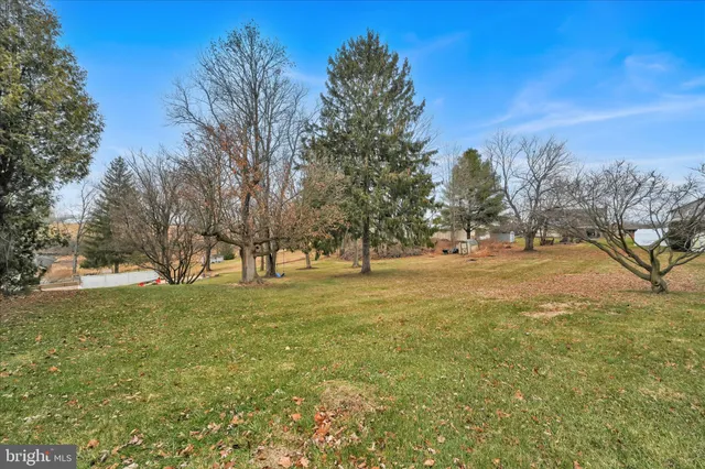 a view of a house with a yard and sitting area