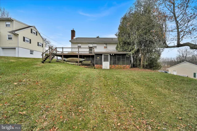 a view of a house with backyard porch and sitting area
