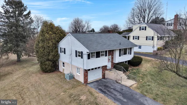 a white house that has a tree in front of it