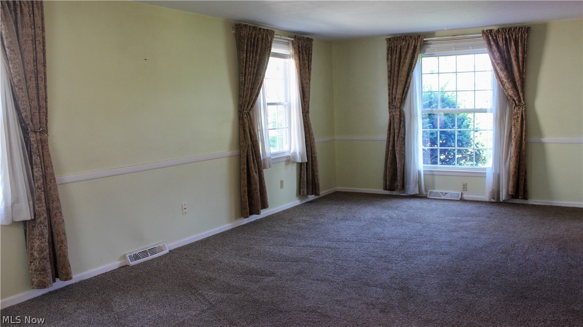 11910 West Lake Road Vermilion, OH 44089 - Photo 7 of 28 Living room featuring carpet and a wealth of natural light