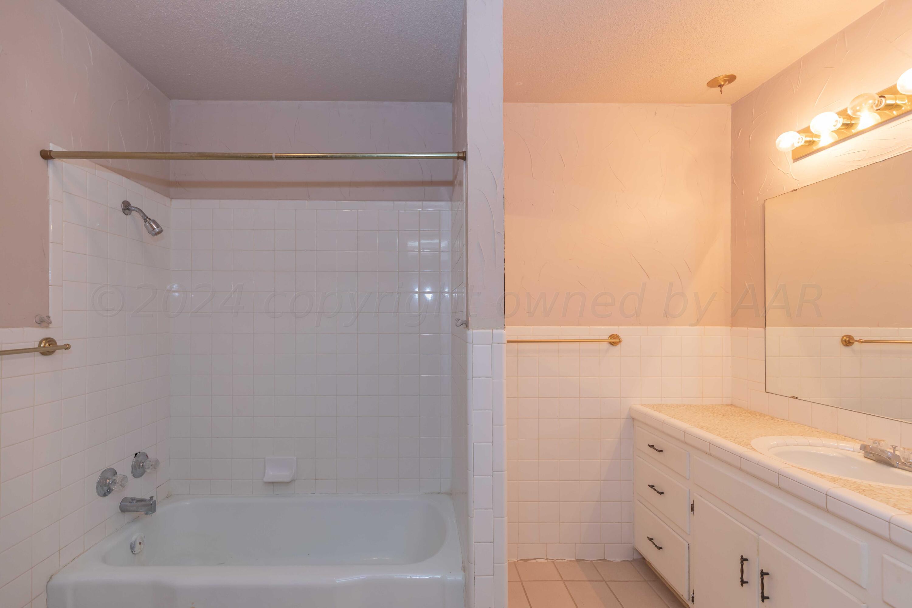 4721 Shawnee Trail Amarillo, TX 79109 - Photo 11 of 52 a bathroom with a bathtub and a sink
