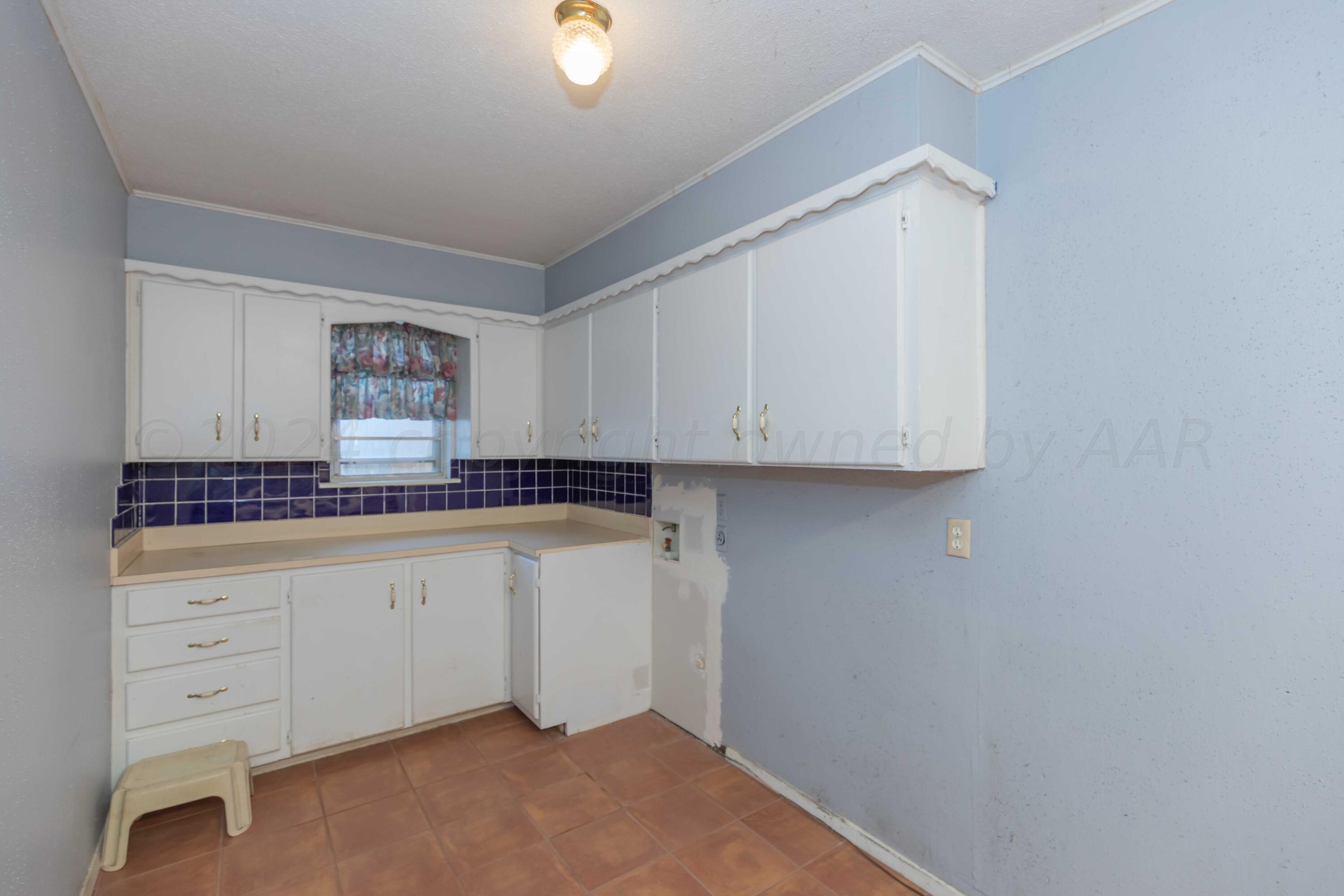 4721 Shawnee Trail Amarillo, TX 79109 - Photo 15 of 52 a room with granite countertop white cabinets and a sink