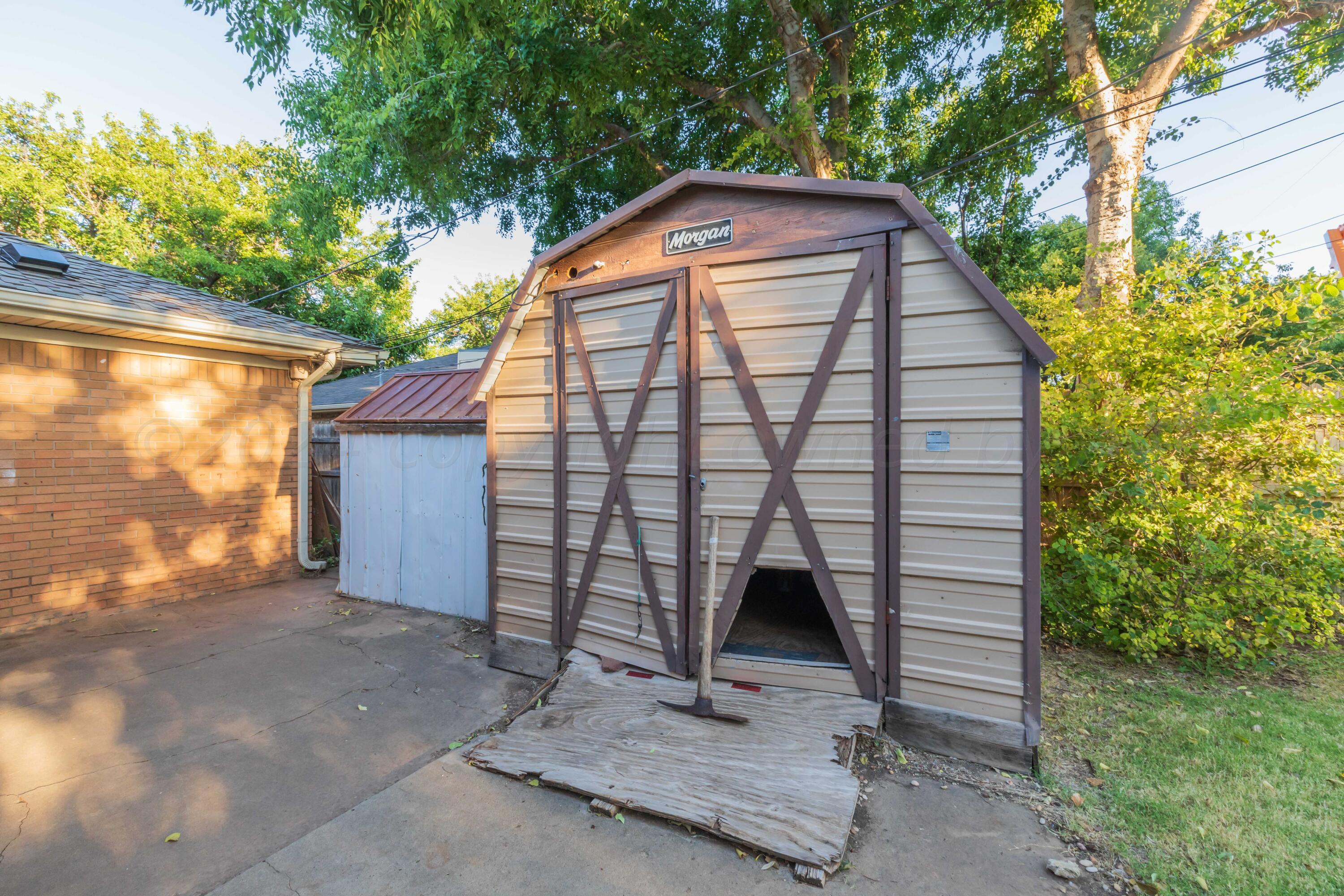 4721 Shawnee Trail Amarillo, TX 79109 - Photo 18 of 52 a front view of a house with a yard