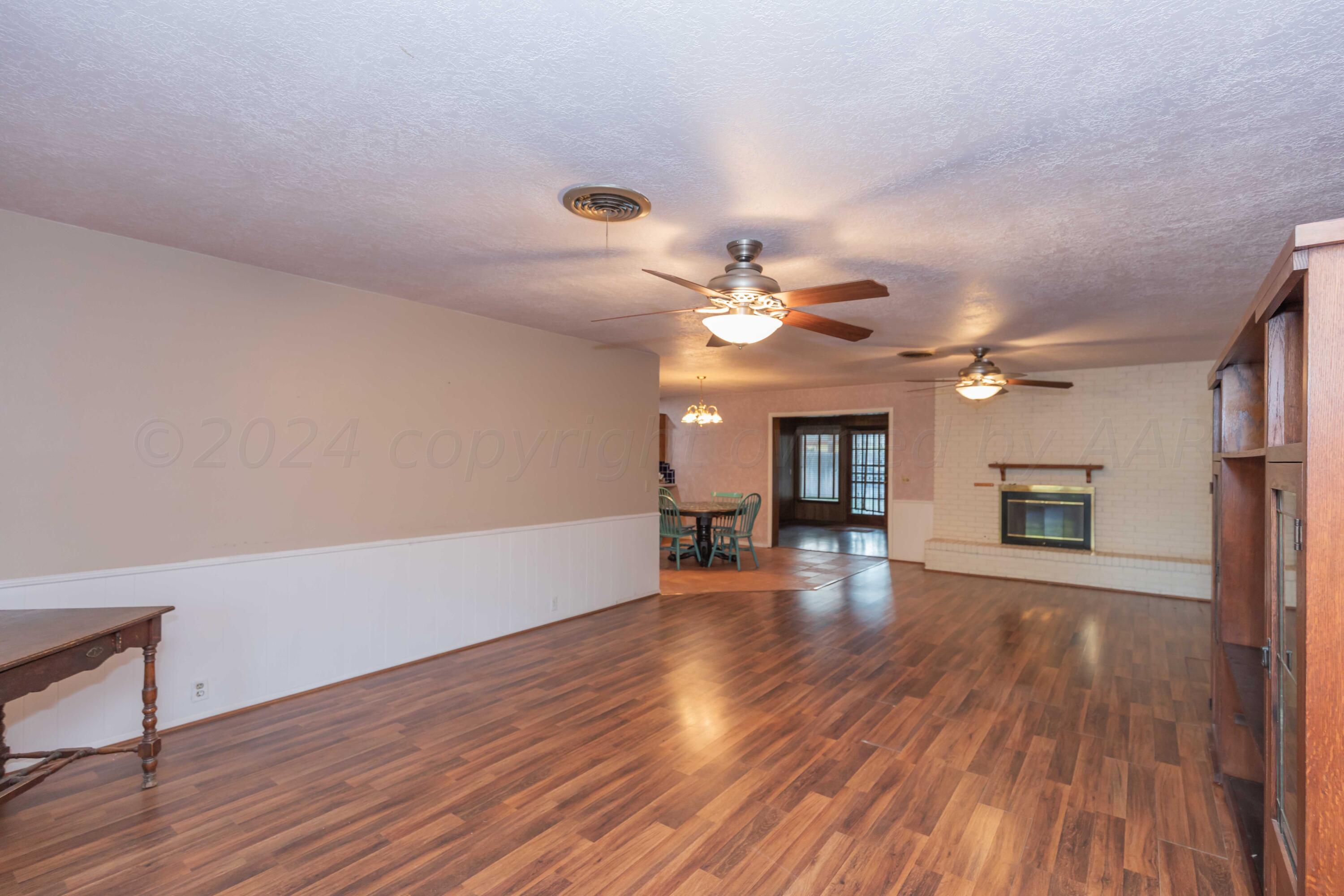 4721 Shawnee Trail Amarillo, TX 79109 - Photo 21 of 52 a view of an empty room with wooden floor and a window