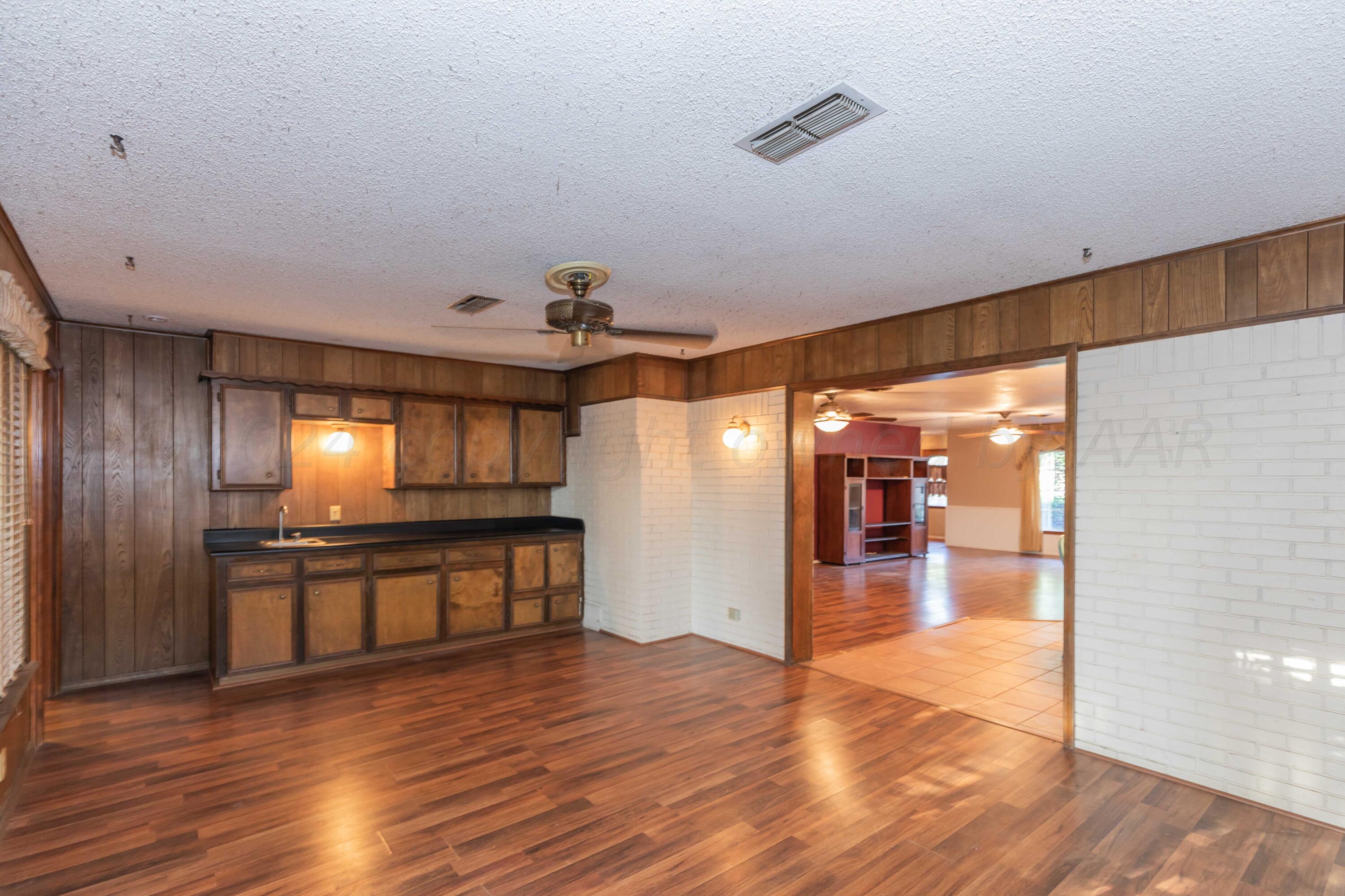 4721 Shawnee Trail Amarillo, TX 79109 - Photo 29 of 52 a view of a lobby area with wooden floor and furniture