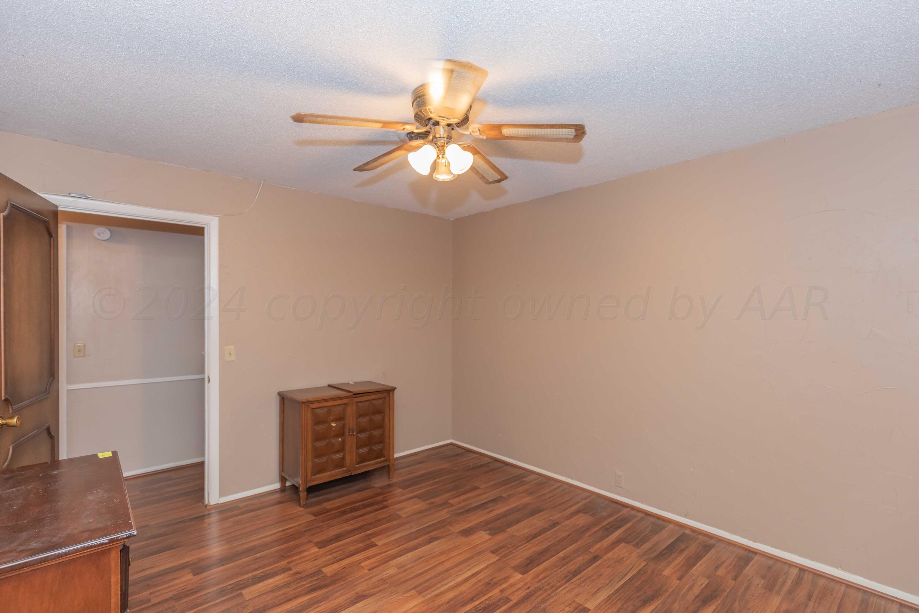 4721 Shawnee Trail Amarillo, TX 79109 - Photo 43 of 52 a view of an empty room with wooden floor