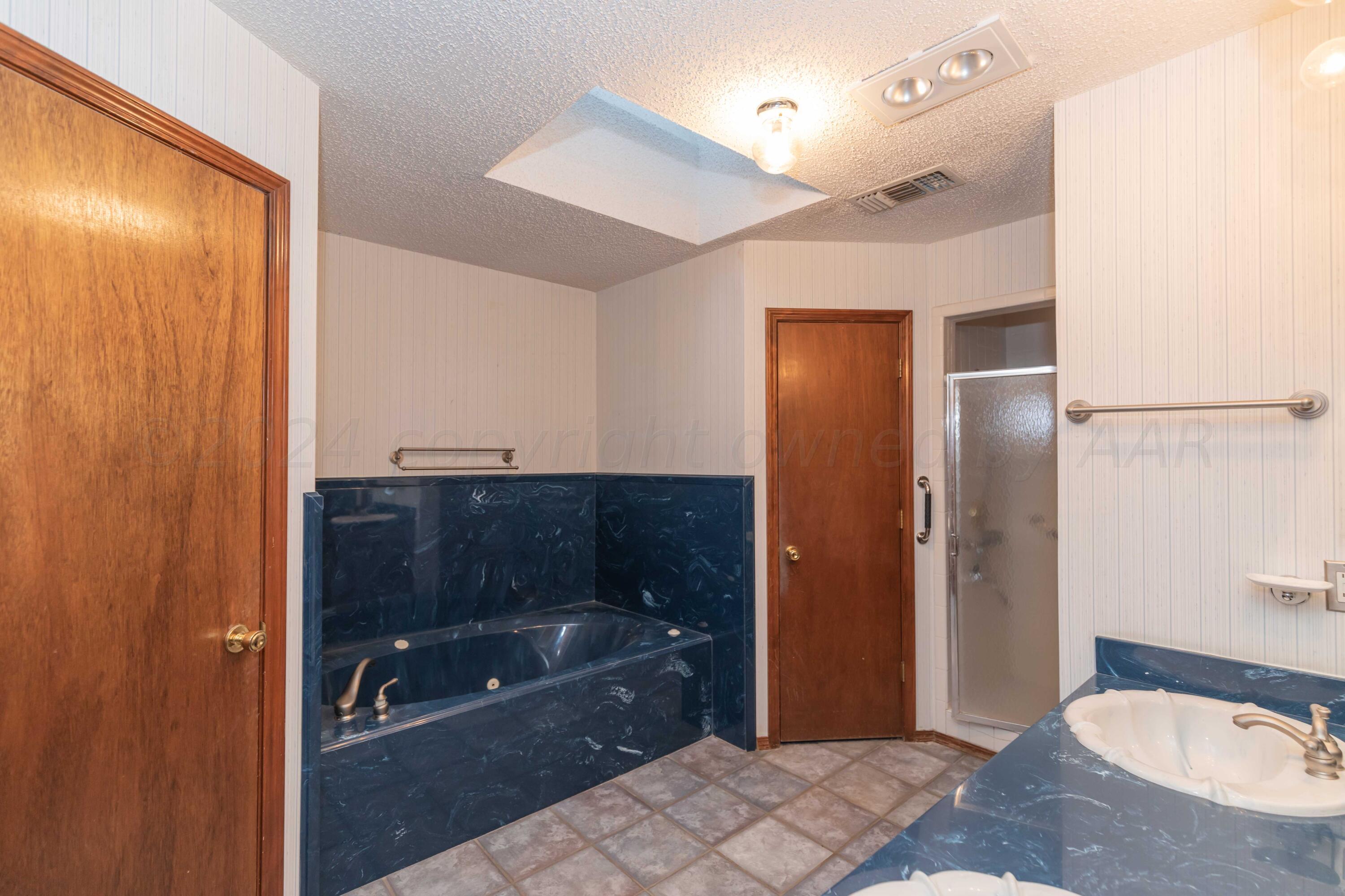 4721 Shawnee Trail Amarillo, TX 79109 - Photo 9 of 52 a bathroom with a sink and a shower