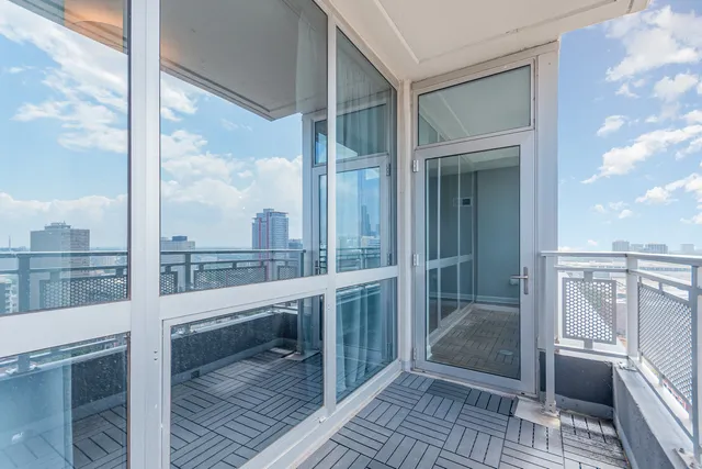 a view of a balcony with a floor to ceiling window with wooden floor