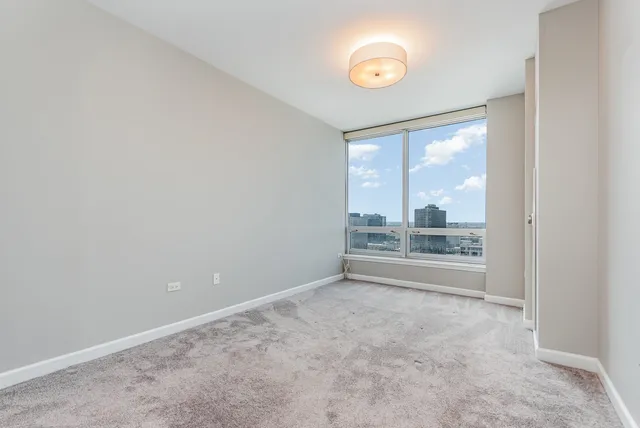 an empty room with large windows