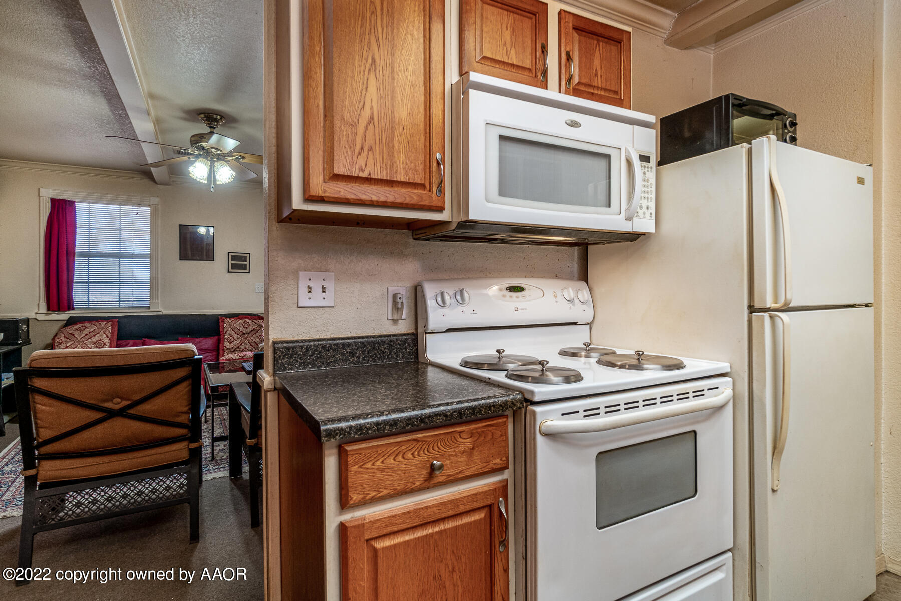 23350 Brown Road Canyon, TX 79015 - Photo 21 of 50 a kitchen with stainless steel appliances granite countertop a stove and a microwave