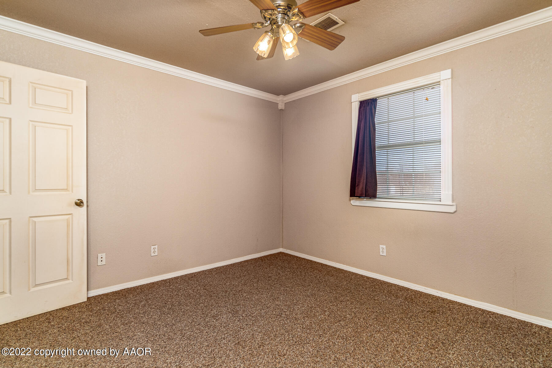 23350 Brown Road Canyon, TX 79015 - Photo 28 of 50 an empty room with a chandelier fan and windows