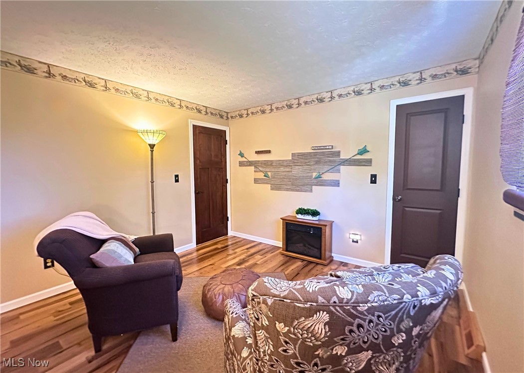 157 Birch Road Painesville, OH 44077 - Photo 17 of 41 bedroom with a textured ceiling, wood finished floors, and baseboards