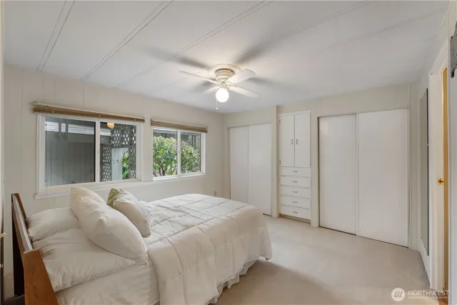 a bedroom with a large bed and a window