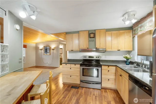 a view of a house with porch and wooden fence