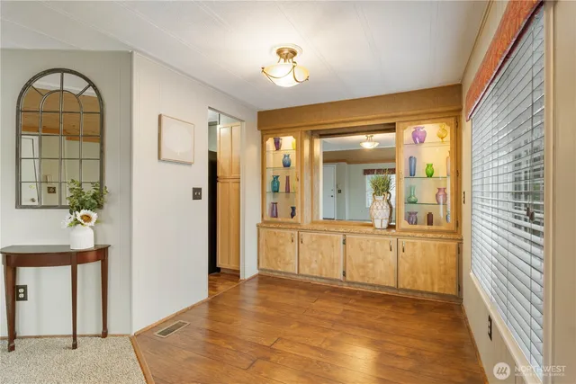 a kitchen that has a table chairs refrigerator and cabinets