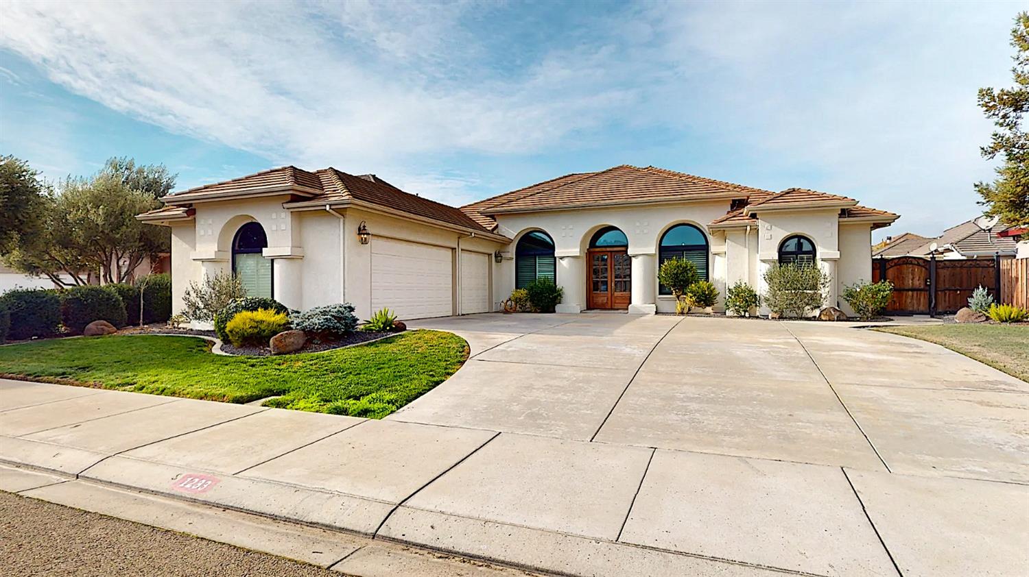 1233 Buzzini Court Ripon, CA 95366 - Photo 1 of 1 a front view of a house with a garden
